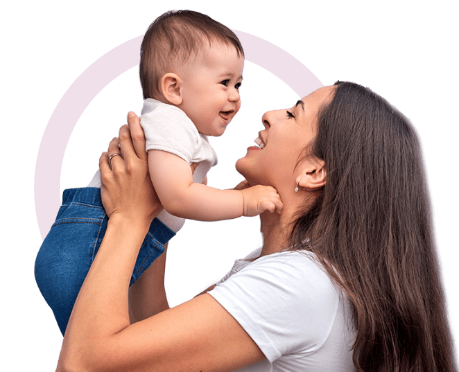 A mom smiles and holds her baby in the air